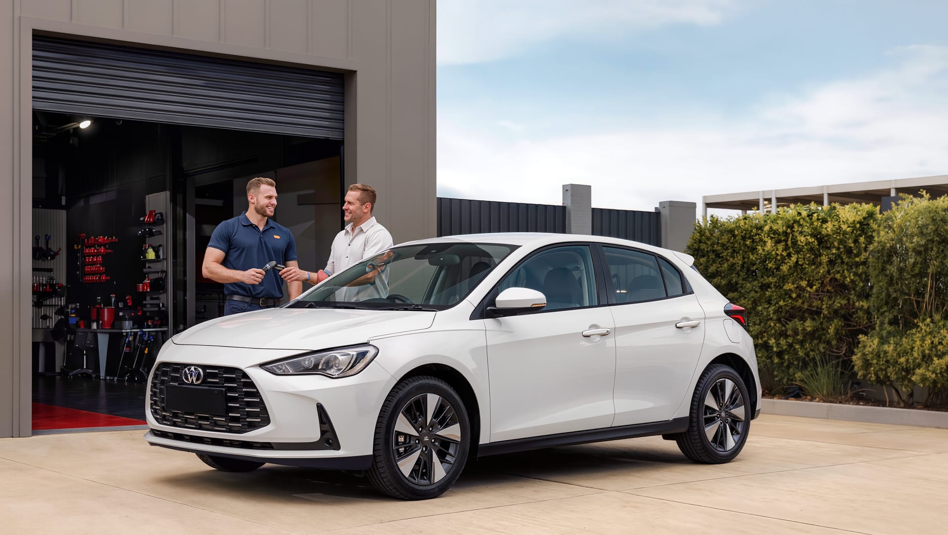 Customer receiving the keys to a replacement car outside the workshop