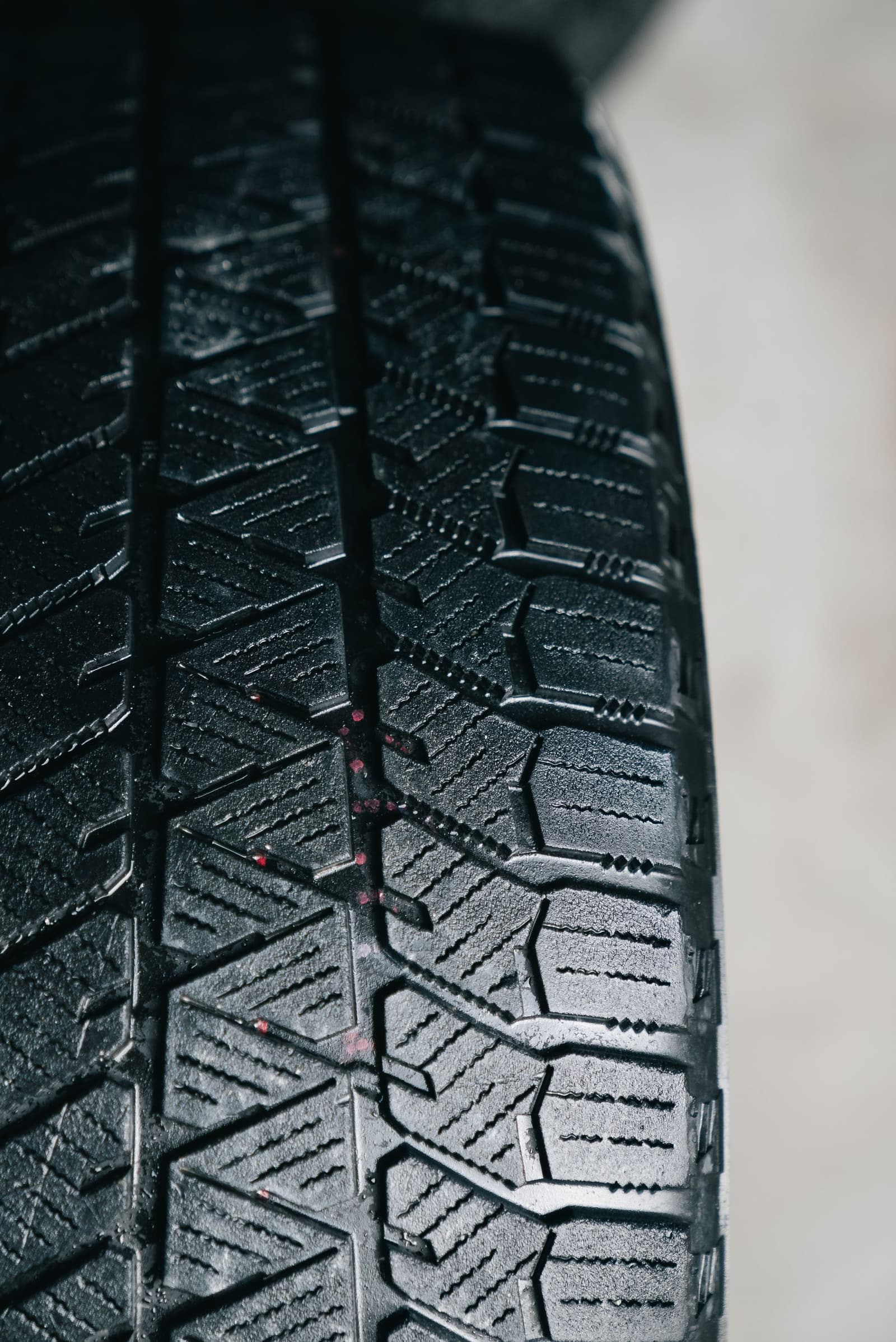 Close-up of tyre tread being checked for wear