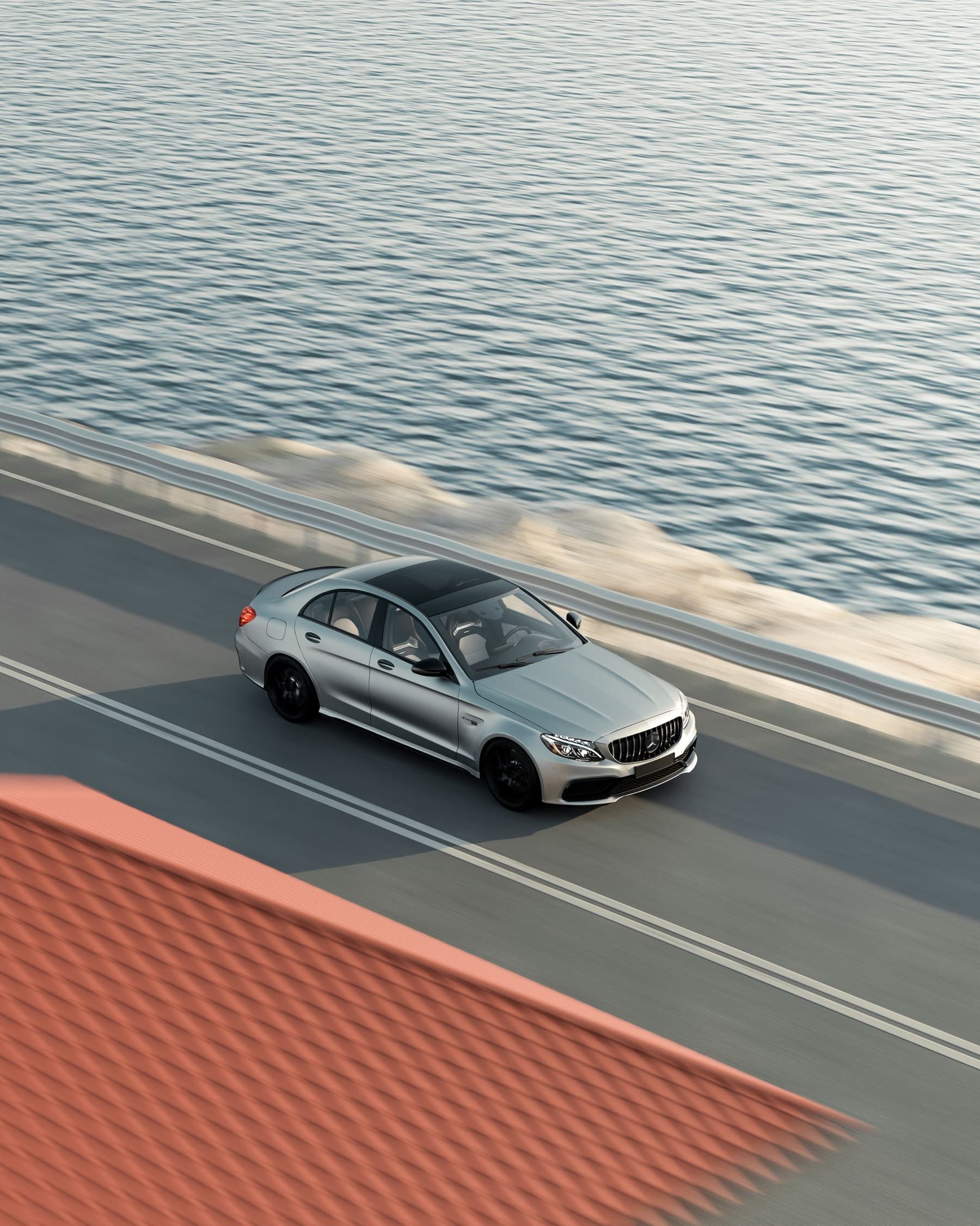 Premium sedan on an open coastal road in daylight