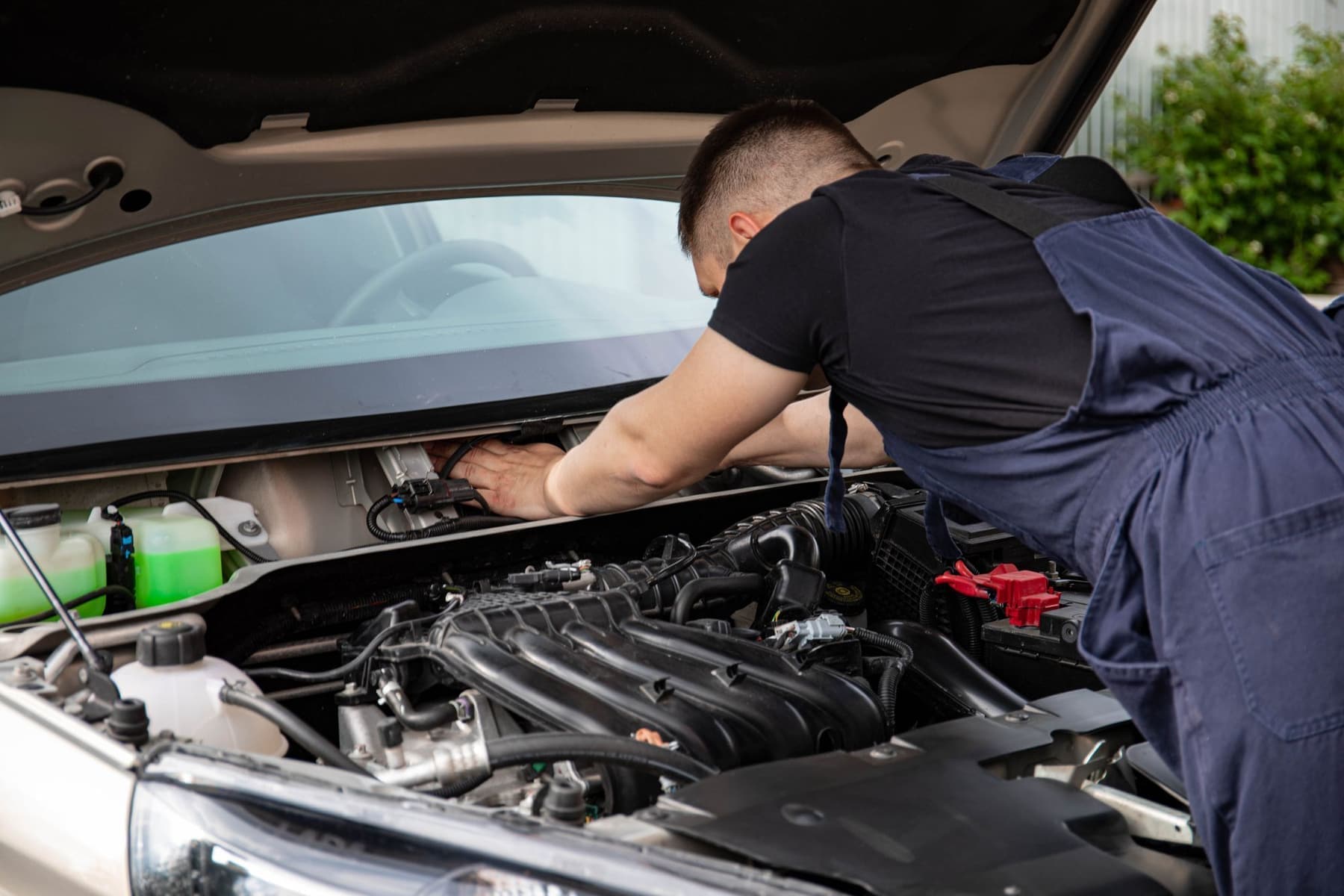 Close-up of a mechanic's hands working on an engine bay