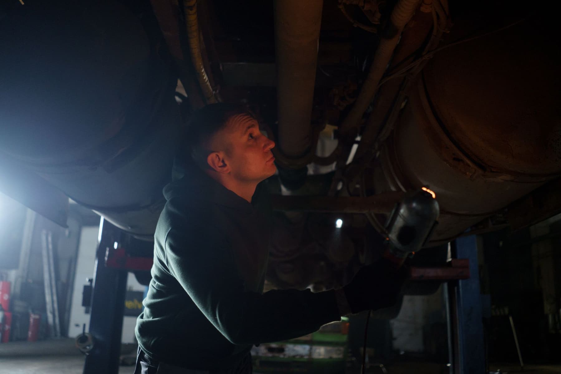 Technician inspecting a vehicle against a detailed service checklist